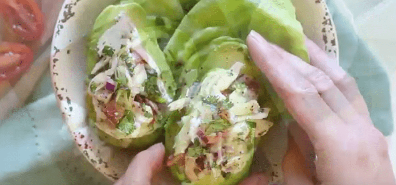 Combine the crabmeat, remaining lime juice, lemon juice, mayonnaise, cilantro, scallion, pepper and salt in a mixing bowl; mix well. Divide this mixture between each avocado half, piling it high. Garnish with extra cilantro, if desired.