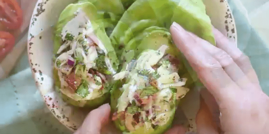 Combine the crabmeat, remaining lime juice, lemon juice, mayonnaise, cilantro, scallion, pepper and salt in a mixing bowl; mix well. Divide this mixture between each avocado half, piling it high. Garnish with extra cilantro, if desired.